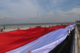Polres Tanjung Perak Beri Ucapan Selamat Pelantikan Jokowi-Amin Lewat Parade Bendera di Suramadu